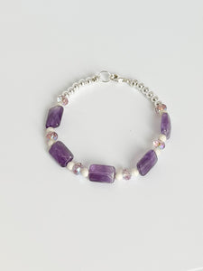 Natural amethyst gemstone bracelet with sterling silver accents and clasp.